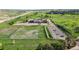 Aerial view of a grassy school grounds with a large parking lot at 6519 Pinewood Dr, Parker, CO 80134