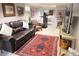 Basement living room includes a sofa, lounge chairs, a television and workout equipment at 832 S Gilpin St, Denver, CO 80209
