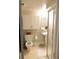Bathroom featuring a toilet, a pedestal sink, vanity storage, and a shower with a glass door at 832 S Gilpin St, Denver, CO 80209