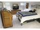 Basement bedroom features a queen bed, dresser, desk and a relaxing sitting area at 832 S Gilpin St, Denver, CO 80209