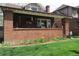 Charming brick home with a well-manicured lawn and colorful flower bed adding to its curb appeal at 832 S Gilpin St, Denver, CO 80209