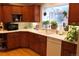 Beautiful kitchen with wood cabinets, stainless appliances, and a window offering exterior view at 832 S Gilpin St, Denver, CO 80209