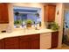 Well-lit kitchen with a garden window over the sink offering views of the yard and lots of natural light at 832 S Gilpin St, Denver, CO 80209