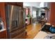 Bright kitchen showcases stainless steel refrigerator and flows seamlessly into the dining area at 832 S Gilpin St, Denver, CO 80209
