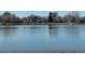 Picturesque lake view with still waters reflecting the sky, trees, and surrounding landscape at 832 S Gilpin St, Denver, CO 80209