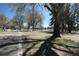 Scenic park with a paved path, lush trees, and a serene lake, offering a peaceful retreat at 832 S Gilpin St, Denver, CO 80209