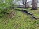 Lawn of a backyard with wooden retaining walls and trees at 5899 Vance St, Arvada, CO 80003