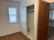 Neat bedroom featuring a closet with sliding doors, a window for natural light, and hardwood floors at 5899 Vance St, Arvada, CO 80003