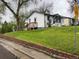 Charming single-Gathering home featuring a sloped lawn and a well-maintained brick retaining wall at 5899 Vance St, Arvada, CO 80003