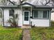 Inviting home entrance with a traditional white door, green trim, and a cozy covered porch at 5899 Vance St, Arvada, CO 80003