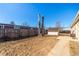 Spacious backyard featuring bare ground, wooden fence, storage shed and a small concrete patio perfect for outdoor activities at 119 Yakima St, Lochbuie, CO 80603