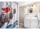 Bathroom featuring a whimsical shower curtain, vanity with sink, and mirror, providing a comfortable and functional space at 119 Yakima St, Lochbuie, CO 80603