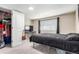Bright bedroom features closet, large window, and modern black bed set at 119 Yakima St, Lochbuie, CO 80603