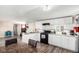 Well-lit kitchen featuring granite countertops, stainless steel appliances, and white cabinetry, open to the living area at 119 Yakima St, Lochbuie, CO 80603