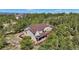 Pictureque aerial view of a home featuring an outdoor deck and manicured grounds at 17575 Minglewood Trl, Monument, CO 80132