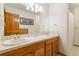 Bathroom with a double sink vanity, framed mirror, and shower with curtain at 17575 Minglewood Trl, Monument, CO 80132