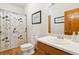 Classic bathroom with a tub-shower combo, white vanity and a framed mirror at 17575 Minglewood Trl, Monument, CO 80132