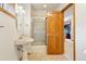 Traditional bathroom showcasing a pedestal sink and shower with glass door at 17575 Minglewood Trl, Monument, CO 80132
