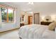Bright bedroom boasts a large window with scenic views and neutral decor at 17575 Minglewood Trl, Monument, CO 80132