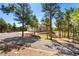 Home with a long paved drive, three-car garage, and stunning landscaping at 17575 Minglewood Trl, Monument, CO 80132