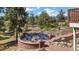 Outdoor fire pit area with comfortable seating, brick surround and scenic views at 17575 Minglewood Trl, Monument, CO 80132