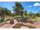 Cozy outdoor fire pit area with seating and lovely landscaping at 17575 Minglewood Trl, Monument, CO 80132