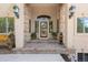 Inviting front entrance with decorative columns, wreath, and stone pavers at 17575 Minglewood Trl, Monument, CO 80132