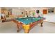 Basement game room with a pool table, comfortable seating, and access to the outdoors at 17575 Minglewood Trl, Monument, CO 80132