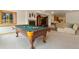 Finished basement with a pool table, fireplace, and entertainment area at 17575 Minglewood Trl, Monument, CO 80132
