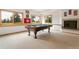Basement game room featuring a pool table, fireplace, and scenic views at 17575 Minglewood Trl, Monument, CO 80132
