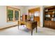 Bright home office featuring a wood desk with a view and built in shelving at 17575 Minglewood Trl, Monument, CO 80132
