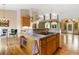 Bright kitchen island with cooktop and cabinetry, seamlessly flowing into other rooms at 17575 Minglewood Trl, Monument, CO 80132