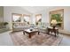 Bright living room featuring a large patterned rug, two sofas and large windows with natural light at 17575 Minglewood Trl, Monument, CO 80132