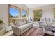 Inviting living room with large windows showcasing scenic views and comfortable seating at 17575 Minglewood Trl, Monument, CO 80132