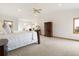 Bright, large main bedroom with a vaulted ceiling, fireplace, carpeted floors, and a window with scenic views at 17575 Minglewood Trl, Monument, CO 80132