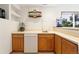 Basement wet bar area with custom cabinets, mini fridge, and scenic view from the window at 17575 Minglewood Trl, Monument, CO 80132