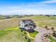 Aerial view featuring a two-story home with an attached garage and a green yard at 3654 Paintbrush Ln, Parker, CO 80138