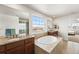 Bright bathroom showcasing a soaking tub, a walk in shower and dual vanities at 3654 Paintbrush Ln, Parker, CO 80138