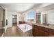 Bright bathroom featuring a soaking tub, a walk in shower and dual vanities at 3654 Paintbrush Ln, Parker, CO 80138