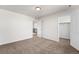 A bright bedroom featuring neutral walls, carpet floors, and a walk-in closet at 3654 Paintbrush Ln, Parker, CO 80138