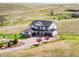 Stunning two-story home boasting a three-car garage and beautifully landscaped front yard on a sunny day at 3654 Paintbrush Ln, Parker, CO 80138