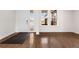 Inviting foyer featuring hardwood floors, a modern front door, and plenty of natural light at 3654 Paintbrush Ln, Parker, CO 80138