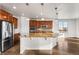 Modern kitchen boasts a large island, stainless appliances, and an open layout to the living area at 3654 Paintbrush Ln, Parker, CO 80138