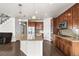 Open kitchen featuring a large granite island, stainless steel appliances, and modern light fixtures at 3654 Paintbrush Ln, Parker, CO 80138