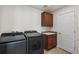 Laundry room featuring washer, dryer, cabinetry, and sink at 3654 Paintbrush Ln, Parker, CO 80138