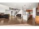 Open-concept floorplan features hardwood floors, staircase, and kitchen island at 3654 Paintbrush Ln, Parker, CO 80138
