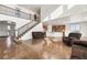 Open-concept living space features staircase to second floor, kitchen, and seating area at 3654 Paintbrush Ln, Parker, CO 80138
