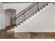 Staircase with wooden railing and carpeted steps leads to upper level at 3654 Paintbrush Ln, Parker, CO 80138