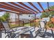 Cozy backyard deck with pergola, fire pit, and comfortable seating, perfect for outdoor entertaining at 4912 Altura St, Denver, CO 80239