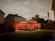 Backyard featuring a pergola-covered deck, green lawn, and privacy fence at dusk at 4912 Altura St, Denver, CO 80239